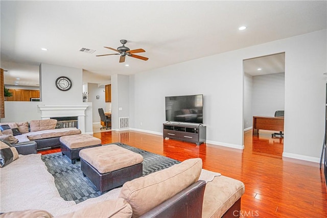 6221 Ruby Crest Way, Jurupa Valley, CA 91752 - living area featuring wood finished floors, a ceiling fan, recessed lighting, and a glass covered fireplace