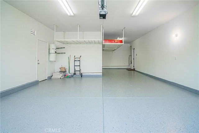 6221 Ruby Crest Way, Jurupa Valley, CA 91752 - garage featuring a garage door opener and baseboards