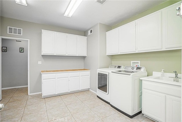 6221 Ruby Crest Way, Jurupa Valley, CA 91752 - laundry room featuring washing machine and clothes dryer, cabinet space, and light tile patterned floors