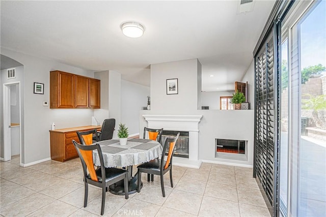 6221 Ruby Crest Way, Jurupa Valley, CA 91752 - dining room with a glass covered fireplace and light tile patterned floors