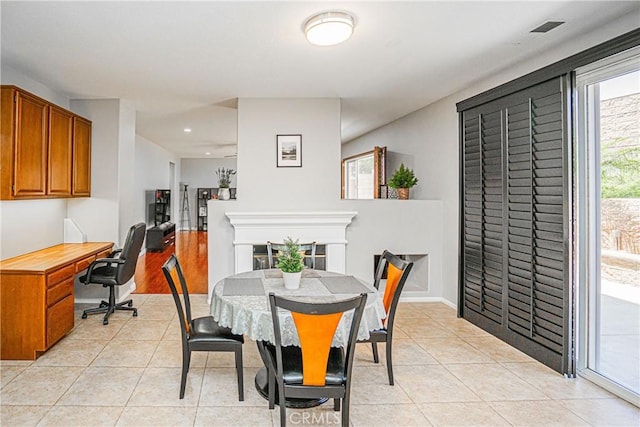 6221 Ruby Crest Way, Jurupa Valley, CA 91752 - dining space with a desk, light tile patterned floors, recessed lighting, and a fireplace
