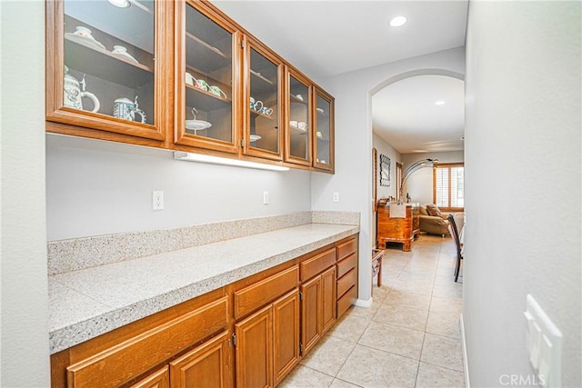6221 Ruby Crest Way, Jurupa Valley, CA 91752 - bar with arched walkways, light tile patterned floors, and recessed lighting