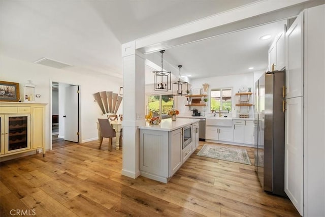 7635 Sombrilla Ave, Atascadero, CA 93422 - kitchen featuring appliances with stainless steel finishes, light countertops, light wood finished floors, open shelves, and recessed lighting