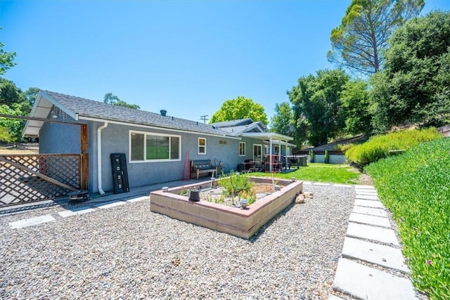 7635 Sombrilla Ave, Atascadero, CA 93422 - rear view of house with stucco siding, a patio area, and a garden