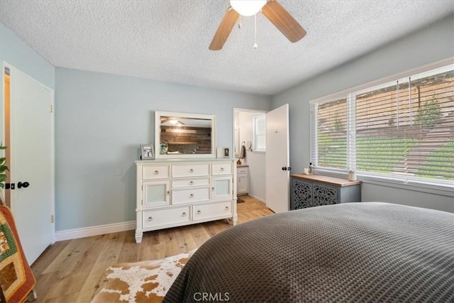 7635 Sombrilla Ave, Atascadero, CA 93422 - bedroom featuring light wood-style floors, a textured ceiling, a ceiling fan, and ensuite bath