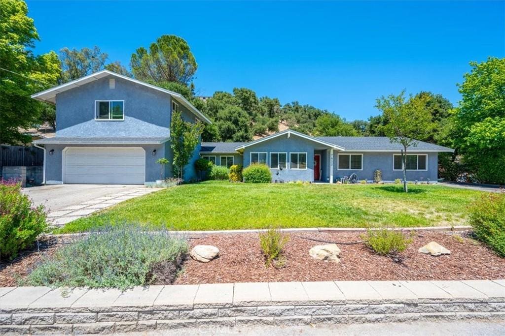 7635 Sombrilla Ave, Atascadero, CA 93422 - view of front of property featuring a garage, concrete driveway, a front yard, and stucco siding