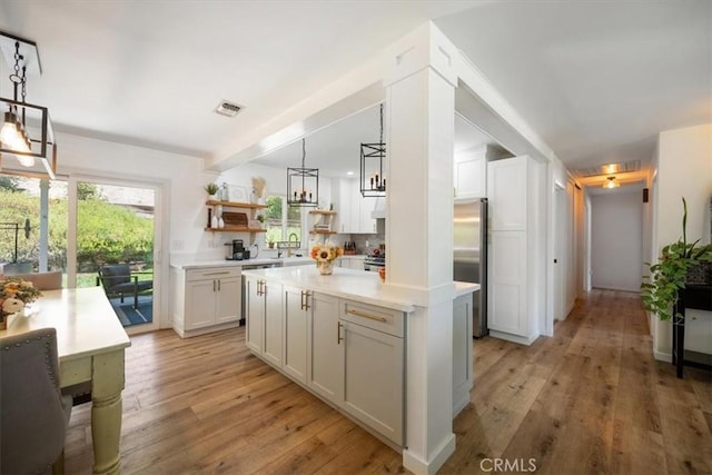 7635 Sombrilla Ave, Atascadero, CA 93422 - kitchen with stainless steel refrigerator, light wood-style flooring, open shelves, and light countertops