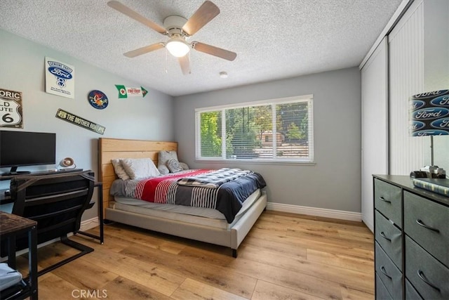 7635 Sombrilla Ave, Atascadero, CA 93422 - bedroom with light wood finished floors, a textured ceiling, a ceiling fan, and a closet