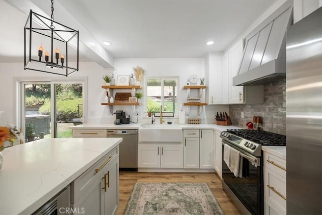 7635 Sombrilla Ave, Atascadero, CA 93422 - kitchen featuring stainless steel appliances, open shelves, wall chimney range hood, healthy amount of natural light, and recessed lighting