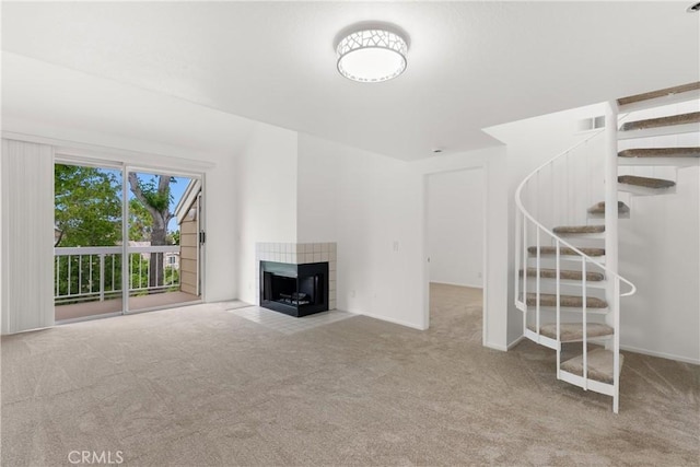 20331 Bluffside Unit A408, Huntington Beach, CA 92646 - unfurnished living room featuring carpet flooring, stairs, and a fireplace