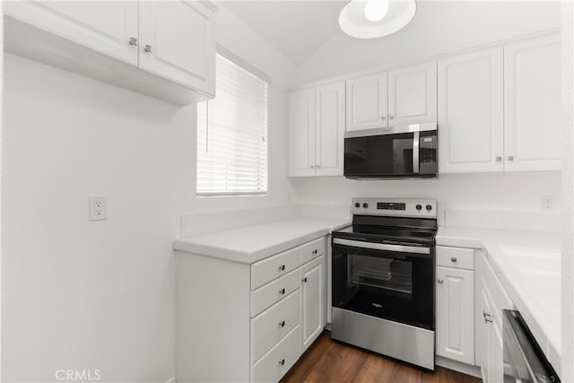 20331 Bluffside Unit A408, Huntington Beach, CA 92646 - kitchen with stainless steel appliances, white cabinetry, light countertops, vaulted ceiling, and dark wood-type flooring