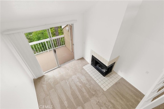 20331 Bluffside Unit A408, Huntington Beach, CA 92646 - unfurnished living room featuring carpet flooring and a tiled fireplace