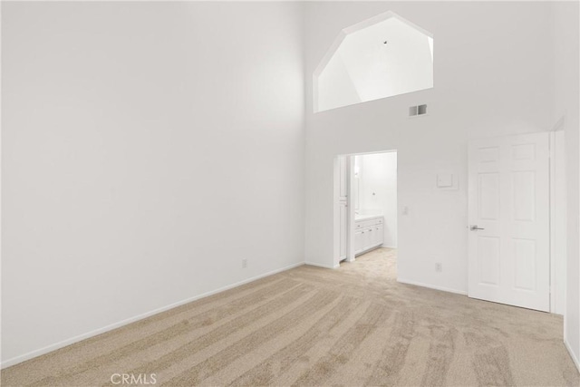 20331 Bluffside Unit A408, Huntington Beach, CA 92646 - unfurnished room featuring light carpet and a towering ceiling