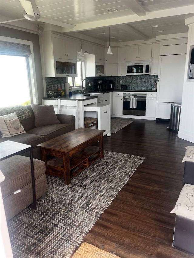 711 Pacific Coast Unit 109, Huntington Beach, CA 92648 - living area with beamed ceiling and dark wood-type flooring