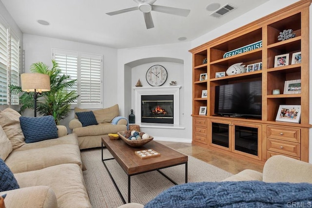 3239 Avenida La Cima, Carlsbad, CA 92009 - living room featuring a ceiling fan, a glass covered fireplace, and built in features