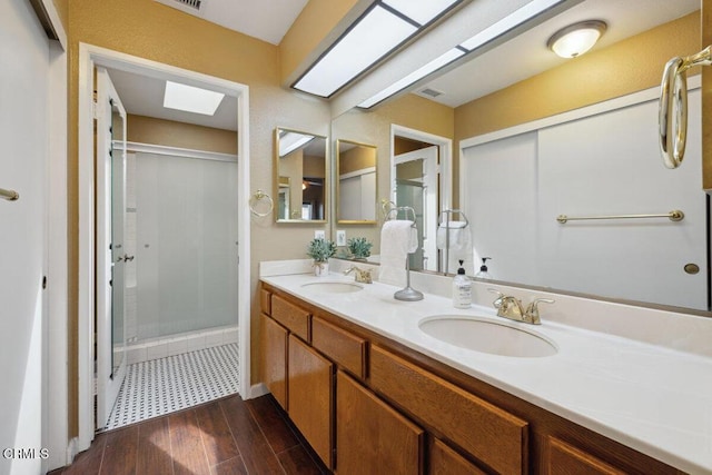 116 La Veta Dr, Camarillo, CA 93012 - full bath featuring a skylight, double vanity, a stall shower, and wood finished floors
