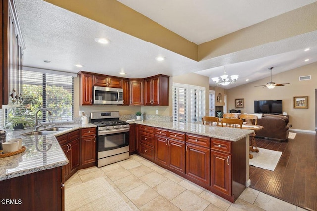 116 La Veta Dr, Camarillo, CA 93012 - kitchen with stainless steel appliances, a peninsula, recessed lighting, light stone counters, and a chandelier
