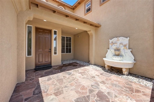 5 Vista Loreta, Lake Elsinore, CA 92532 - view of exterior entry with stucco siding and a patio area