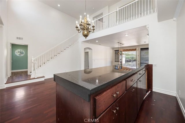 5 Vista Loreta, Lake Elsinore, CA 92532 - kitchen featuring a towering ceiling, arched walkways, dark wood-style flooring, a chandelier, and decorative light fixtures