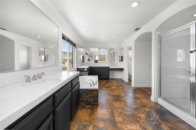 5 Vista Loreta, Lake Elsinore, CA 92532 - bathroom featuring two vanities, a stall shower, ornamental molding, stone finish floors, and a garden tub