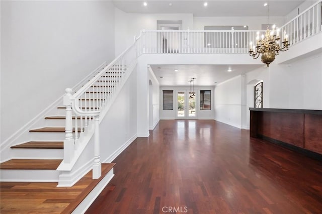 5 Vista Loreta, Lake Elsinore, CA 92532 - unfurnished living room with stairs, wood finished floors, arched walkways, a chandelier, and a towering ceiling
