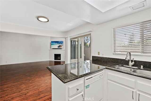12698 Shearer Ln, Garden Grove, CA 92843 - kitchen featuring white dishwasher, a peninsula, white cabinetry, dark wood finished floors, and a fireplace