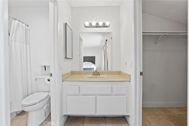 12698 Shearer Ln, Garden Grove, CA 92843 - ensuite bathroom with tile patterned floors, vanity, a walk in closet, and a shower with shower curtain