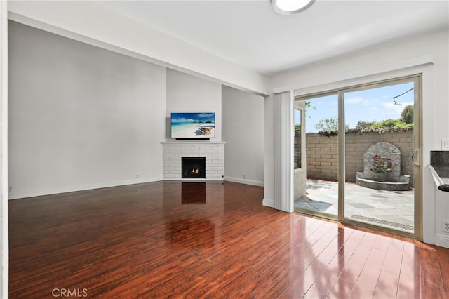 12698 Shearer Ln, Garden Grove, CA 92843 - unfurnished living room featuring a brick fireplace and wood finished floors