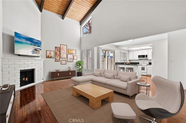 12698 Shearer Ln, Garden Grove, CA 92843 - living area featuring light wood-style flooring, a wood ceiling with exposed beams, high vaulted ceiling, and a fireplace