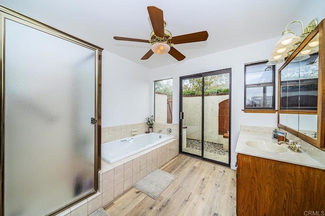 2278 Casitas Del Sol, Fallbrook, CA 92028 - full bath with wood finished floors, vanity, a stall shower, a bath, and a ceiling fan