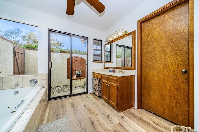 2278 Casitas Del Sol, Fallbrook, CA 92028 - bathroom featuring a jetted tub, ceiling fan, vanity, and plenty of natural light