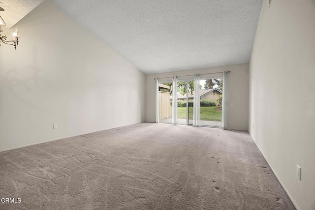 13208 Village 13 Unit 13, Camarillo, CA 93012 - unfurnished living room featuring a textured ceiling, carpet flooring, lofted ceiling, and a chandelier