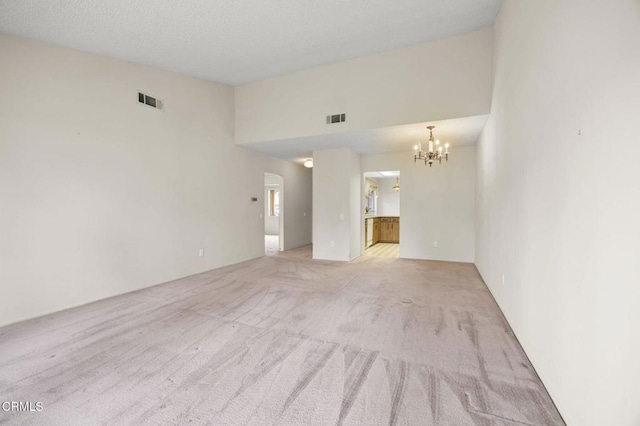 13208 Village 13 Unit 13, Camarillo, CA 93012 - unfurnished living room with a chandelier, light carpet, and a high ceiling