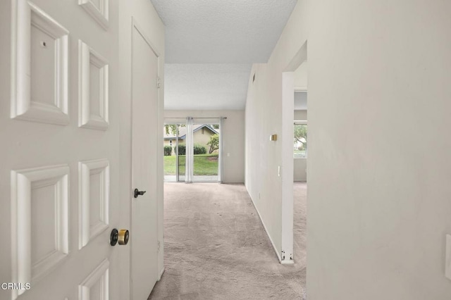 13208 Village 13 Unit 13, Camarillo, CA 93012 - hall with light colored carpet and a textured ceiling