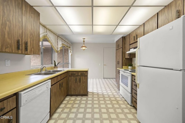 13208 Village 13 Unit 13, Camarillo, CA 93012 - kitchen with white appliances, light flooring, light countertops, under cabinet range hood, and hanging light fixtures