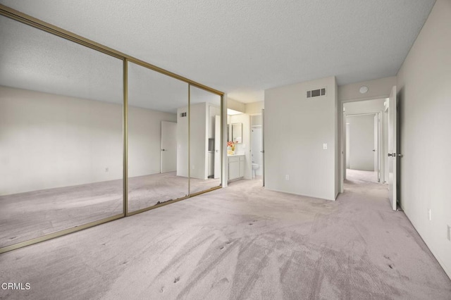 13208 Village 13 Unit 13, Camarillo, CA 93012 - unfurnished bedroom featuring a textured ceiling, carpet, and ensuite bath