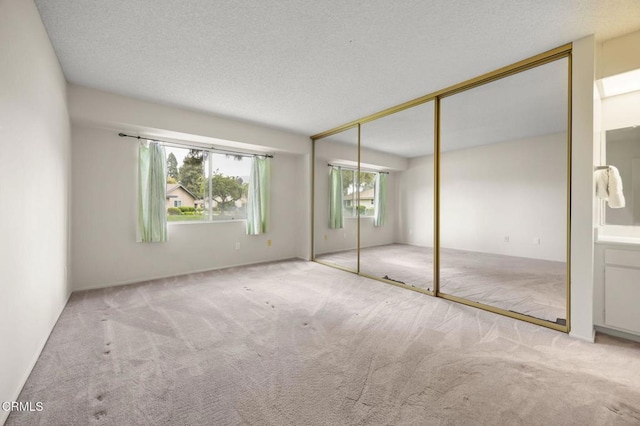 13208 Village 13 Unit 13, Camarillo, CA 93012 - unfurnished bedroom with carpet, a closet, and a textured ceiling