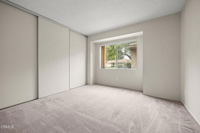 13208 Village 13 Unit 13, Camarillo, CA 93012 - unfurnished bedroom featuring carpet flooring, a closet, and a textured ceiling