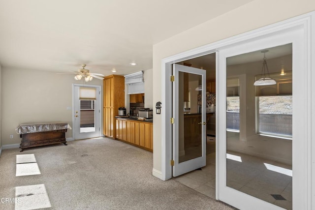 30100 Sunland Way, Tehachapi, CA 93561 - kitchen featuring light colored carpet, a ceiling fan, recessed lighting, brown cabinetry, and pendant lighting