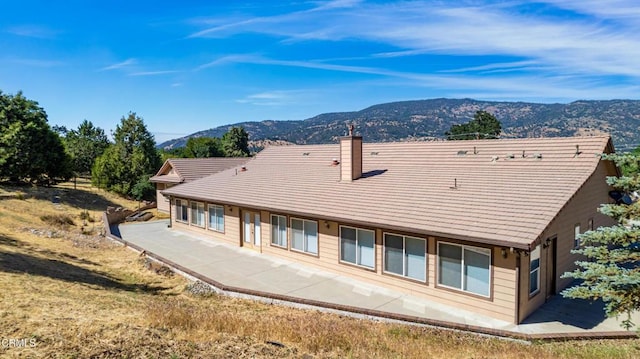 30100 Sunland Way, Tehachapi, CA 93561 - rear view of house with a mountain view, a chimney, and a patio