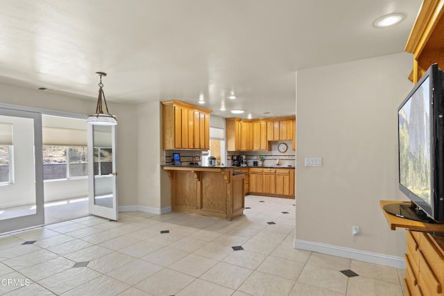 30100 Sunland Way, Tehachapi, CA 93561 - kitchen featuring a peninsula, light tile patterned floors, recessed lighting, hanging light fixtures, and a kitchen bar