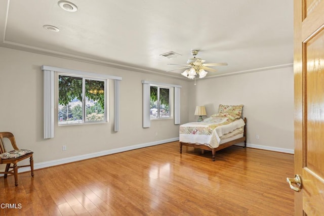 30100 Sunland Way, Tehachapi, CA 93561 - bedroom featuring multiple windows, wood finished floors, and a ceiling fan