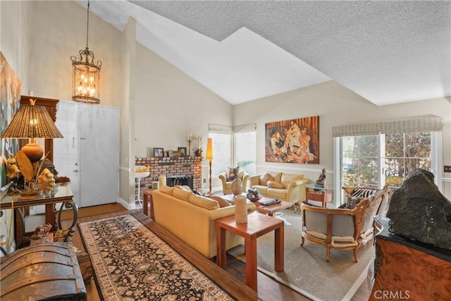 1943 Horseshoe Cir, Placentia, CA 92870 - living room with wood finished floors, a chandelier, a brick fireplace, high vaulted ceiling, and a textured ceiling