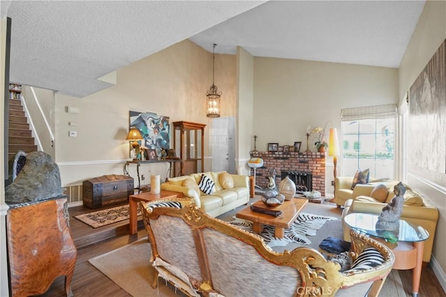 1943 Horseshoe Cir, Placentia, CA 92870 - living room with wood finished floors, a fireplace, high vaulted ceiling, stairs, and a chandelier
