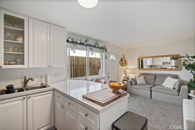 1413 Avenida De La Estrella, San Clemente, CA 92672 - kitchen featuring white cabinetry, glass insert cabinets, a peninsula, and light countertops