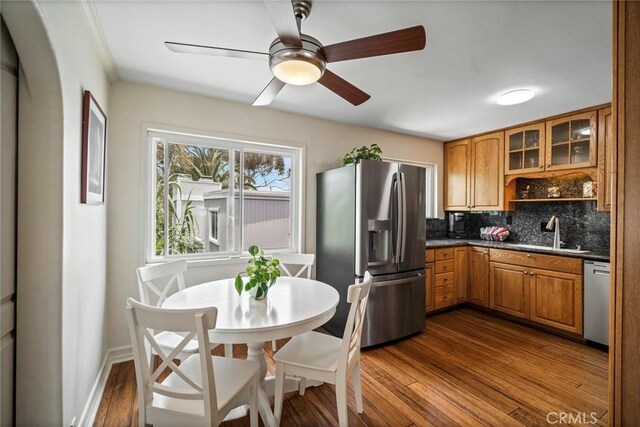 1413 Avenida De La Estrella, San Clemente, CA 92672 - kitchen featuring appliances with stainless steel finishes, brown cabinets, tasteful backsplash, dark wood finished floors, and glass insert cabinets