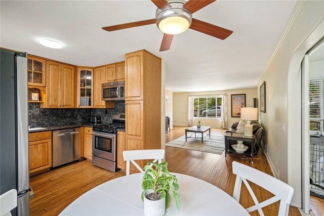 1413 Avenida De La Estrella, San Clemente, CA 92672 - kitchen featuring stainless steel appliances, open floor plan, light wood-type flooring, and backsplash