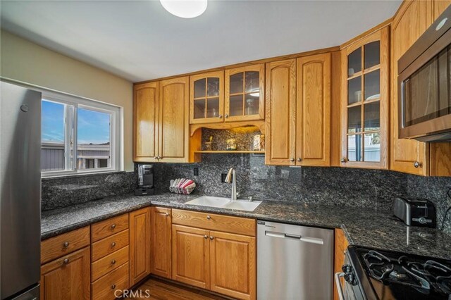 1413 Avenida De La Estrella, San Clemente, CA 92672 - kitchen featuring appliances with stainless steel finishes, backsplash, glass insert cabinets, and brown cabinets