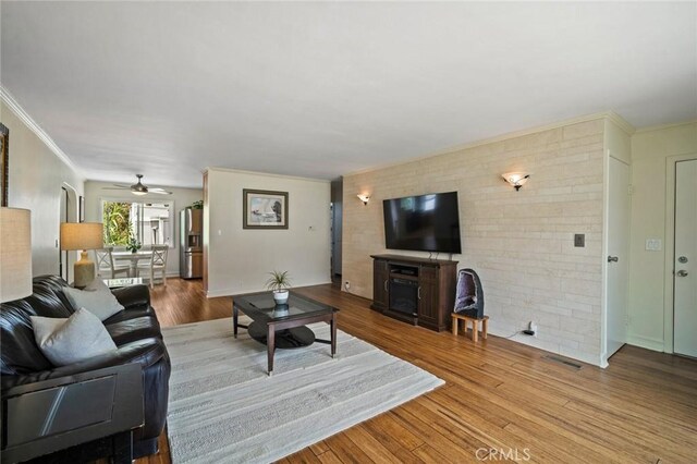 1413 Avenida De La Estrella, San Clemente, CA 92672 - living room with a ceiling fan, wood finished floors, crown molding, brick wall, and a fireplace
