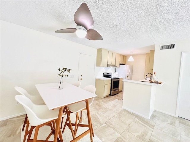 23515 Lyons Ave Unit 232, Valencia, CA 91355 - kitchen featuring stainless steel range with electric stovetop, a textured ceiling, light countertops, a ceiling fan, and white refrigerator with ice dispenser
